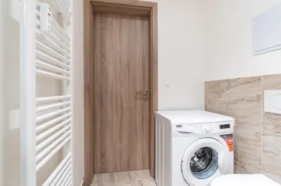 a laundry room with a washer and dryer at Brand new studio apartment #62 with free secure parking in the center in Prague