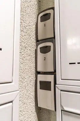 a kitchen with white cabinets with two toasters on the wall at Brand new studio apartment #62 with free secure parking in the center in Prague