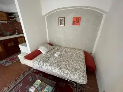 a small bedroom with a bed in the corner at 1 Bed Flat - Sleeps 3 - Courtyard - Wifi in Prague