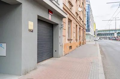 a building with a garage door on the side of a street at Brand new studio apartment #21 with free secure parking in the center in Prague